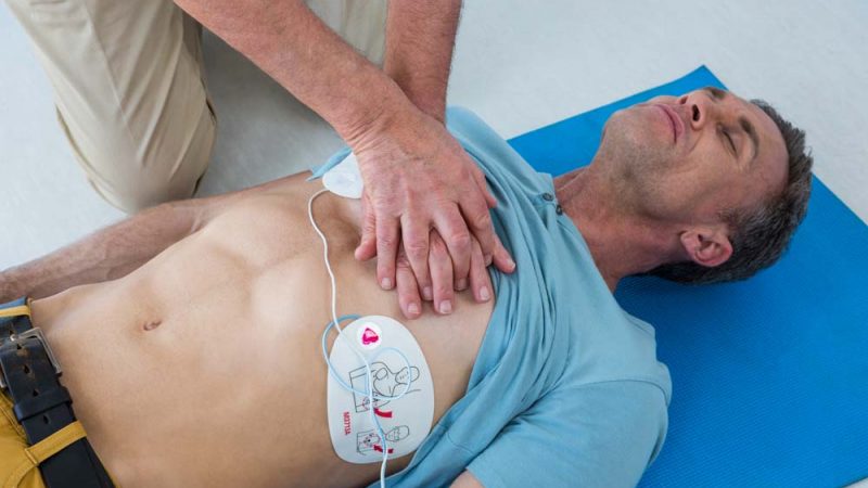 Paramedic performing resuscitation on patient in clinic