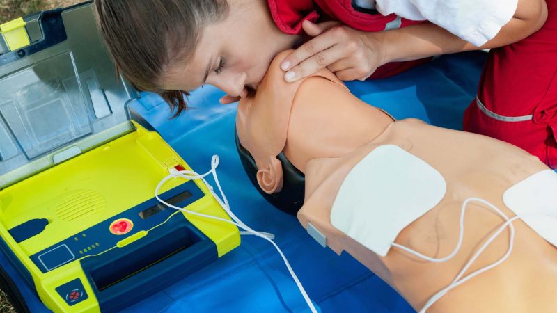 CPR training with defibrillatior on DPR doll